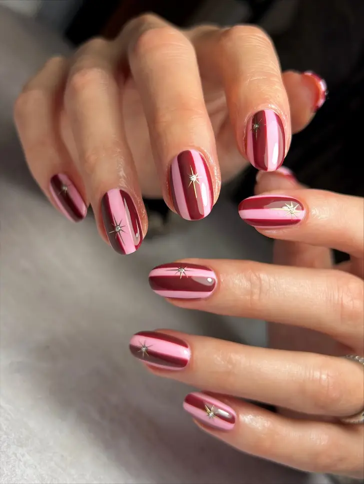 Маникюр с розовыми и бордовыми полосами и золотой звездой