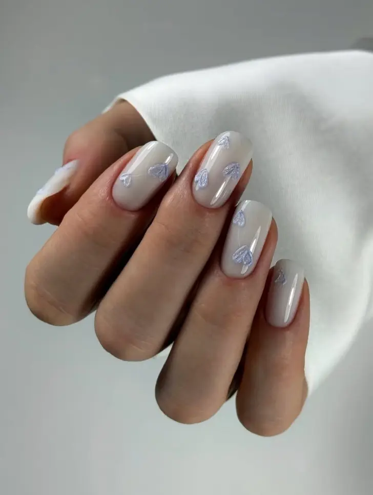 Аккуратный молочный маникюр с холодного тона сердечками