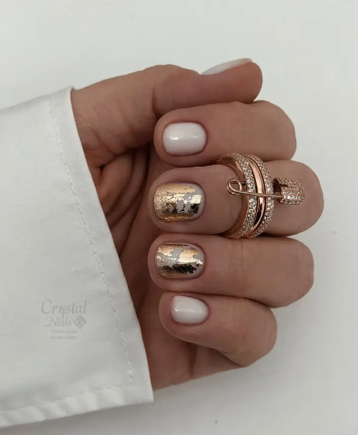 Короткий молочный маникюр на зиму 2026 с золотой фольгой