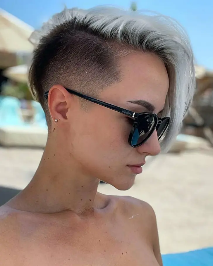 Эффектная прическа с выбритым боком и мелированными волосами зачесанными набок