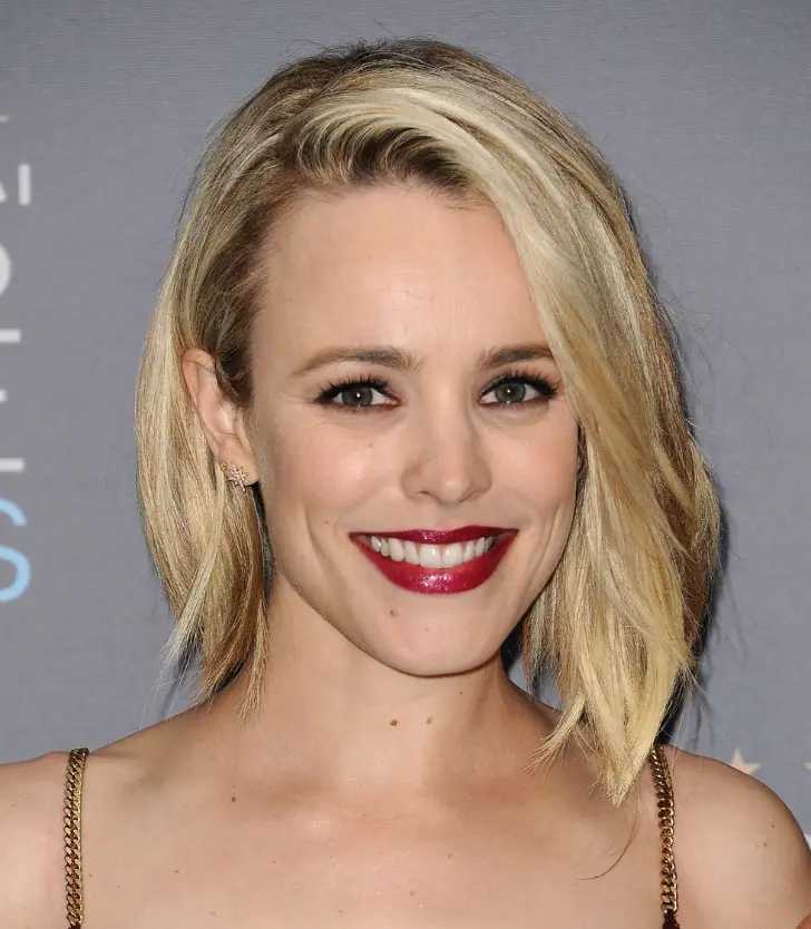 Изящная прическа с челкой закрученной волной на блонд волосах